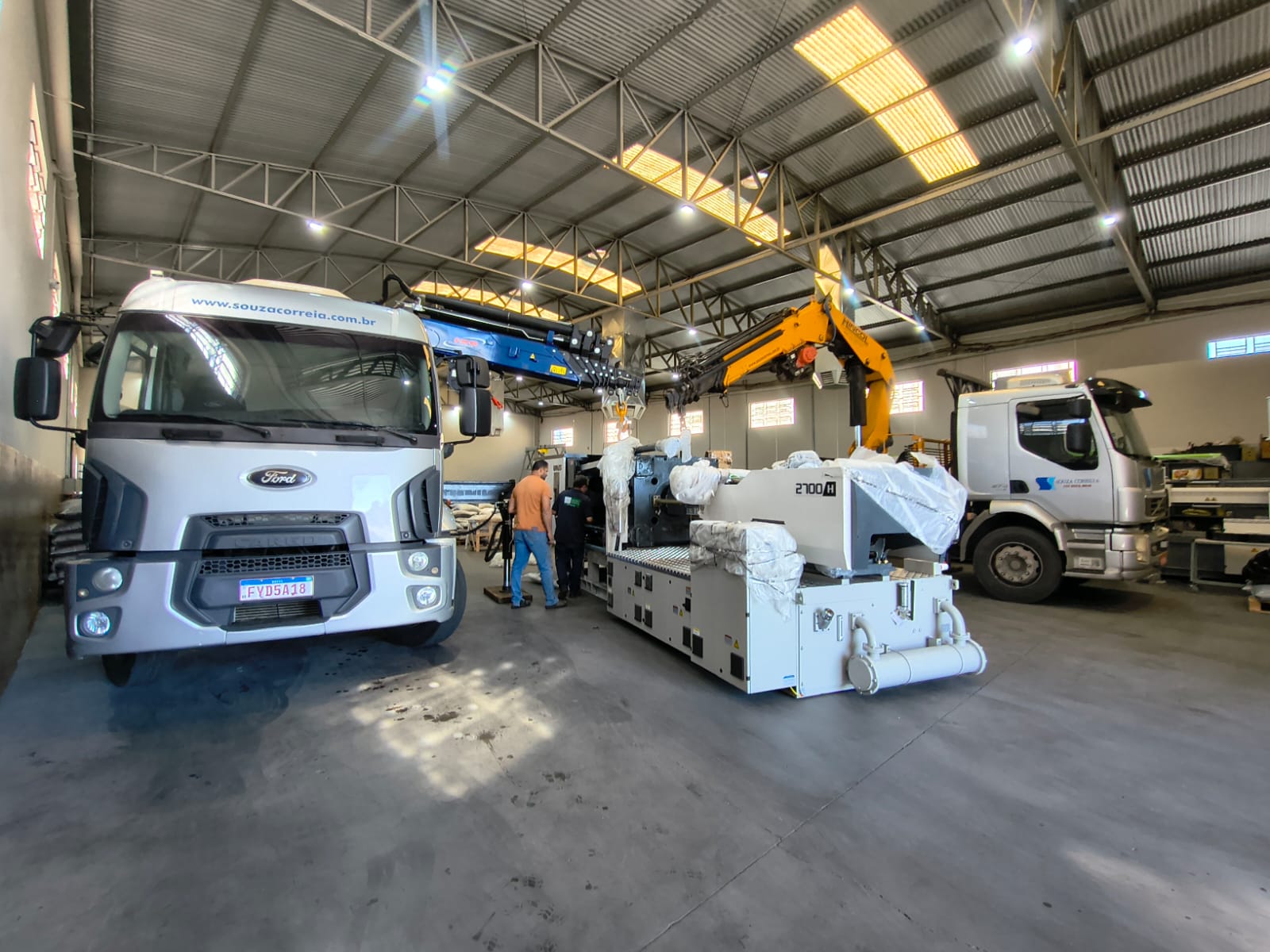 Movimentação de máquina industrial dentro de galpão